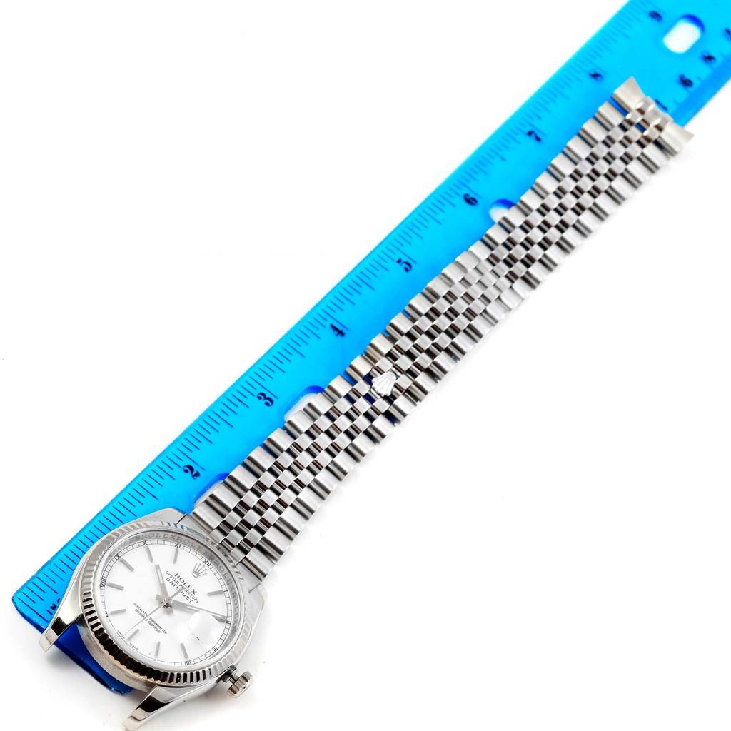 The image shows a Rolex Datejust 116234 Men's Stainless Steel White Dial 116234 Men's Stainless Steel White Dial watch laid flat next to a ruler, highlighting the full band length and face.