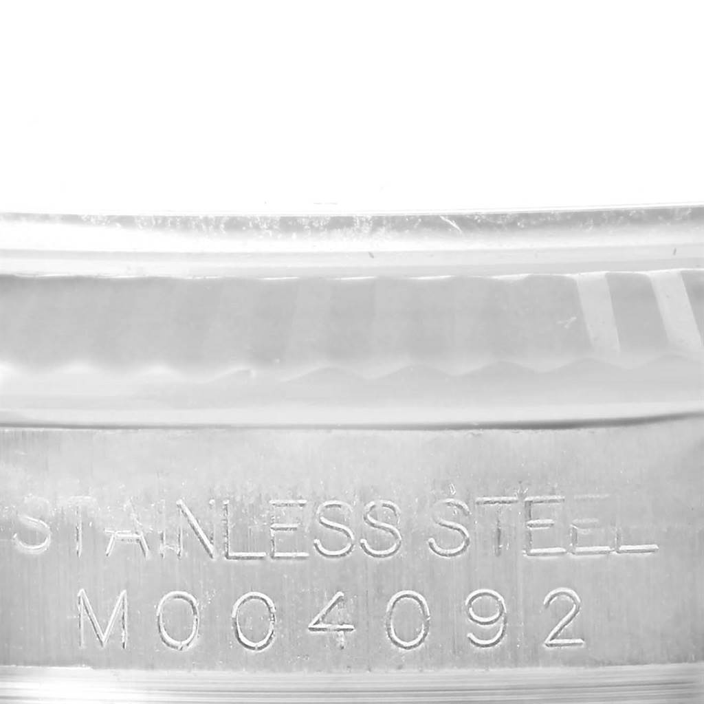 The image shows a close-up of the stainless steel case back of a Rolex Datejust 116234 Men's Stainless Steel White Dial 116234 Men's Stainless Steel White Dial watch with visible engravings.