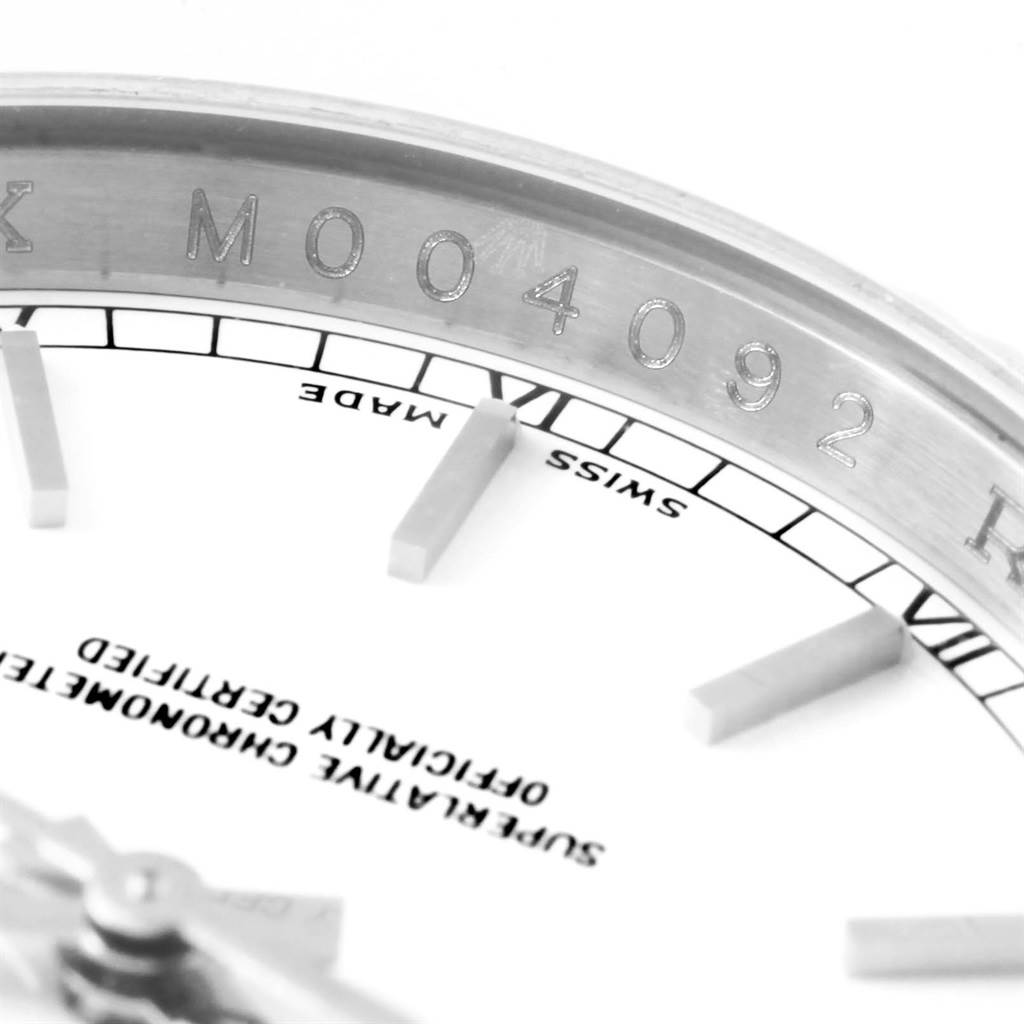 This close-up image shows the serial number and part of the face and indices of a Rolex Datejust 116234 Men's Stainless Steel White Dial 116234 Men's Stainless Steel White Dial watch.