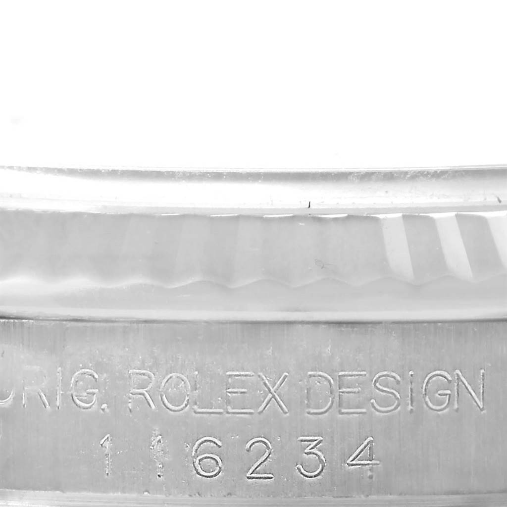 The image shows a close-up of the engraved bezel and serial number of a Rolex Datejust 116234 Men's Stainless Steel White Dial 116234 Men's Stainless Steel White Dial watch.