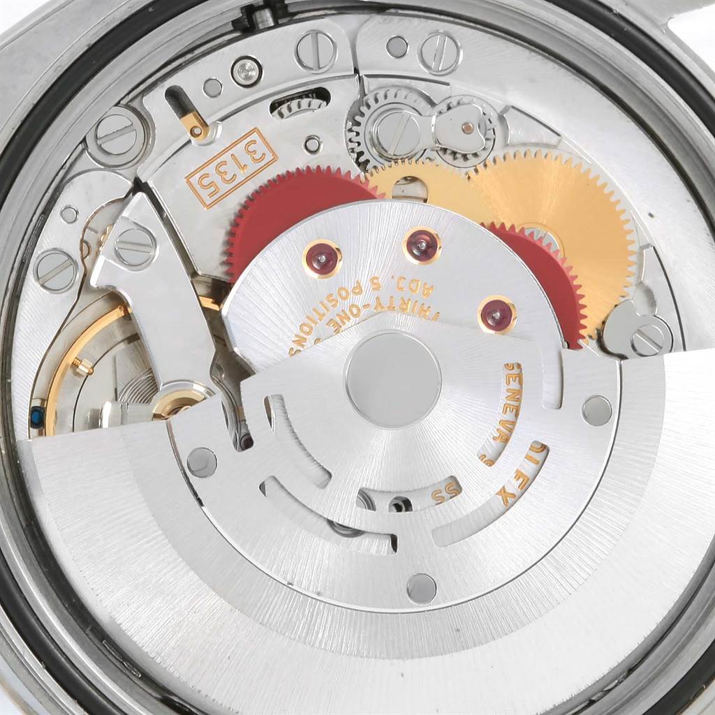 This image shows the intricate internal mechanism of the Rolex Datejust 116234 Men's Stainless Steel White Dial 116234 Men's Stainless Steel White Dial model, including gears, screws, and the rotor.