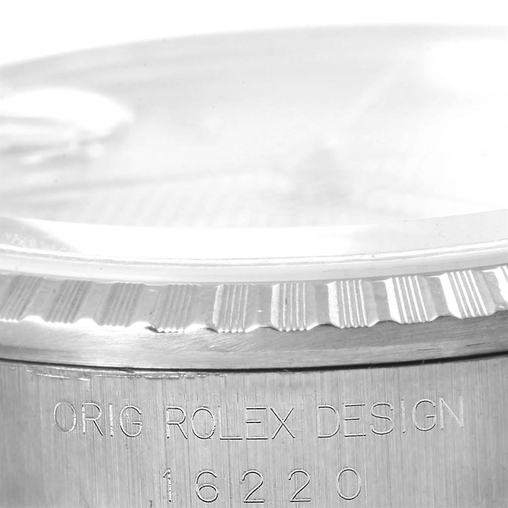 This close-up shows the side of a Rolex Datejust 16220 Men's Stainless Steel Silver Dial 16220 Men's Stainless Steel Silver Dial watch, highlighting the fluted bezel and engraved model number "16220."