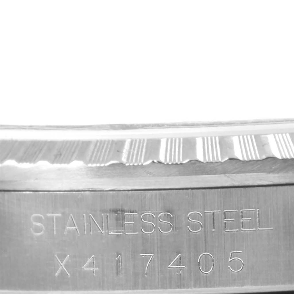 The image shows an angled close-up of the casing side of a Rolex Datejust 16220 Men's Stainless Steel Silver Dial 16220 Men's Stainless Steel Silver Dial watch, displaying "STAINLESS STEEL" and a serial number.
