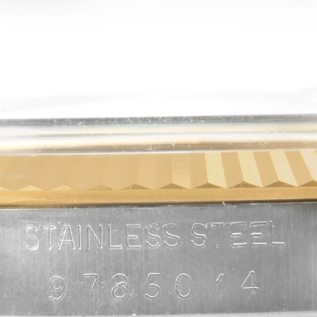 This close-up image shows the stainless steel part of the bezel and the serial number on a Rolex Datejust 16013 Men's Stainless Steel Champagne Dial 16013 Men's Stainless Steel Champagne Dial.