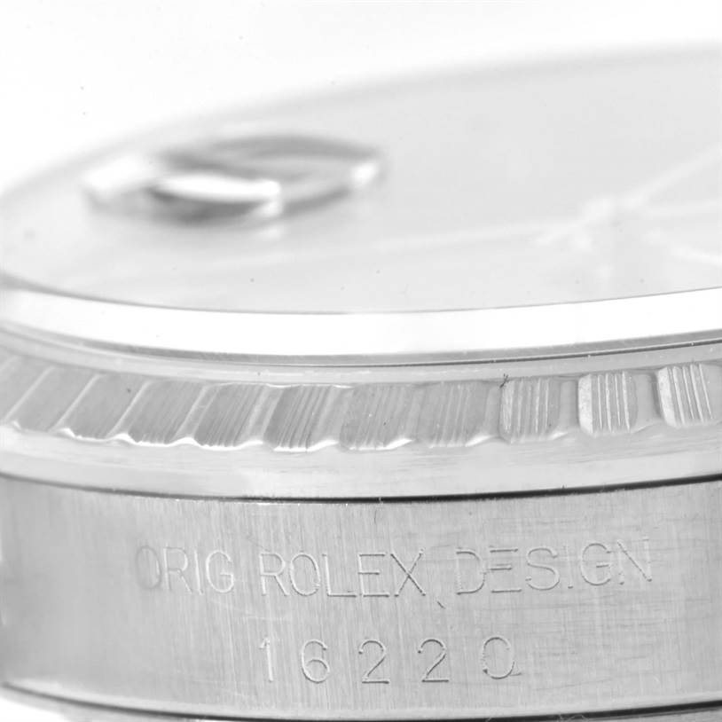 The image shows a close-up of the side profile of a Rolex Datejust 16220 Men's Stainless Steel Black Dial 16220 Men's Stainless Steel Black Dial watch, focusing on the bezel and engraving on the case.