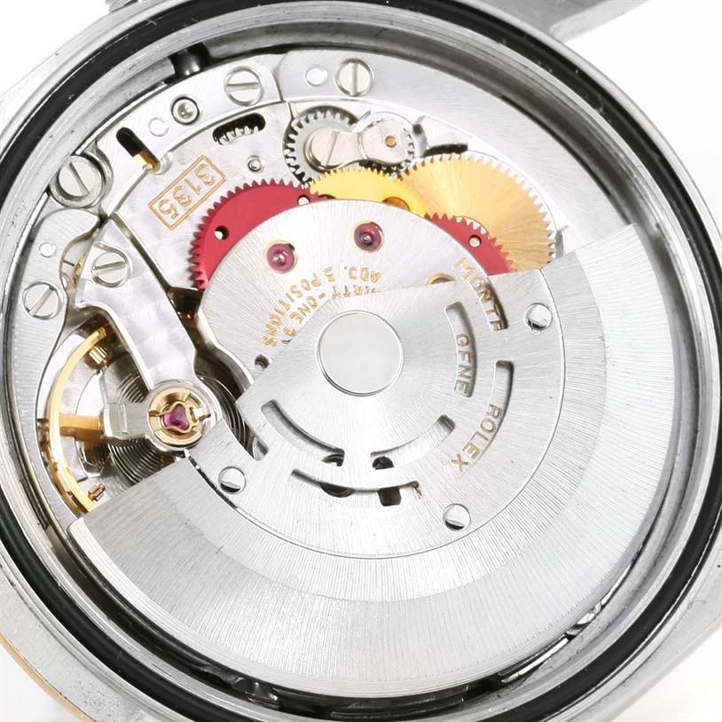 This is a close-up view of the interior mechanism of a Rolex Datejust 16233 Men's Steel and Gold (two tone) Champagne Dial 16233 Men's Steel and Gold (two tone) Champagne Dial watch, showing its intricate gears and components.