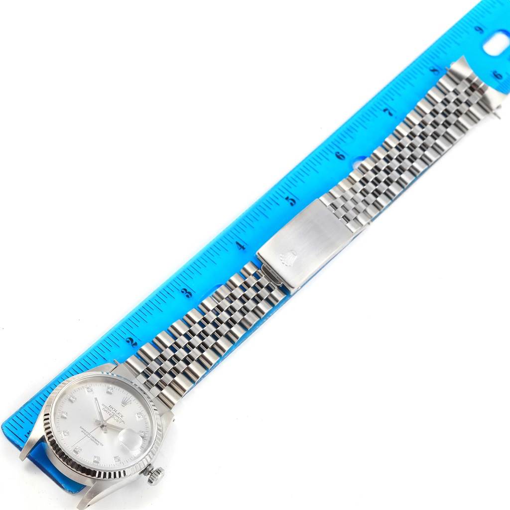 The image shows a Rolex Datejust 16234 Stainless Steel Silver Dial 16234 Stainless Steel Silver Dial watch laid flat with its face, bracelet, and clasp visible alongside a measuring ruler.