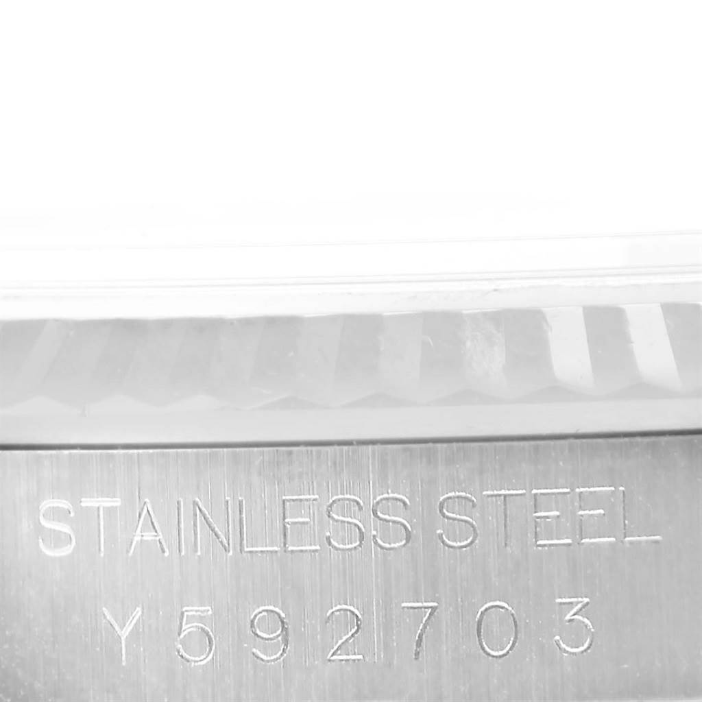 The image shows a close-up view of the engraved serial number and "STAINLESS STEEL" text on the side of a Rolex Datejust 16234 Men's Stainless Steel Silver Dial 16234 Men's Stainless Steel Silver Dial watch.