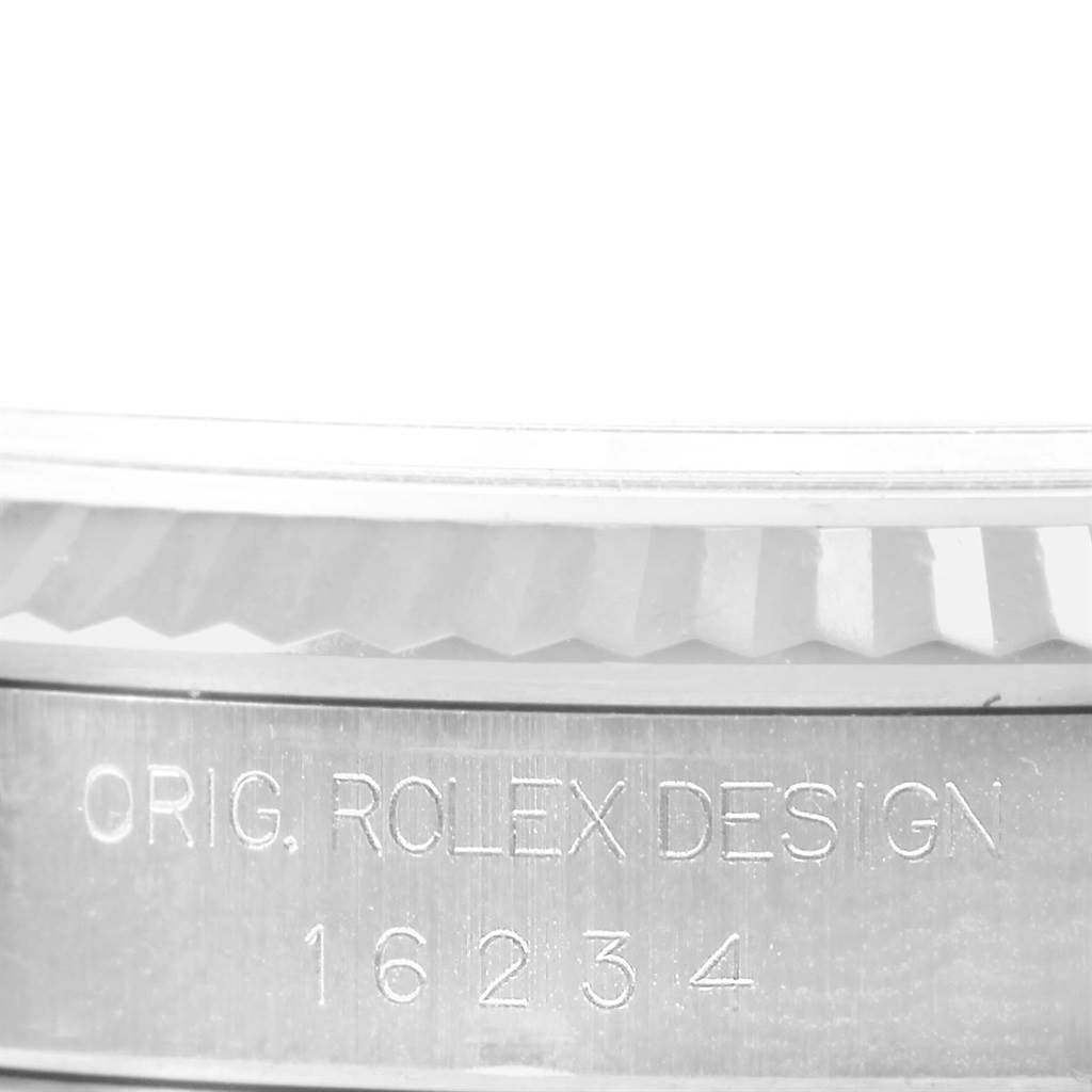 This close-up image shows the engraved case back of a Datejust model by Rolex, highlighting the design details and model number.