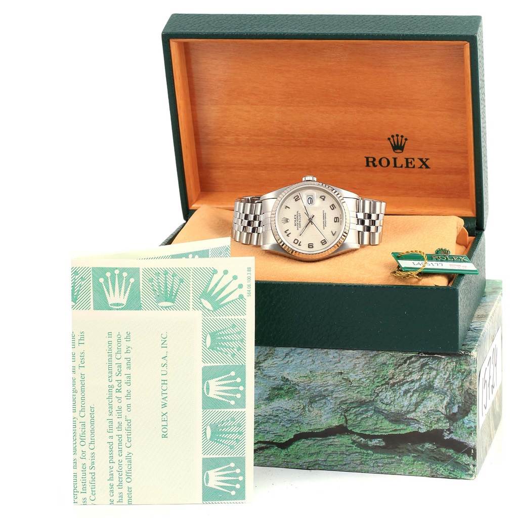 The image shows a Rolex Datejust 16234 Men's Stainless Steel Beige Dial 16234 Men's Stainless Steel Beige Dial watch from a slightly high angle, displayed in an open box with accompanying documents.