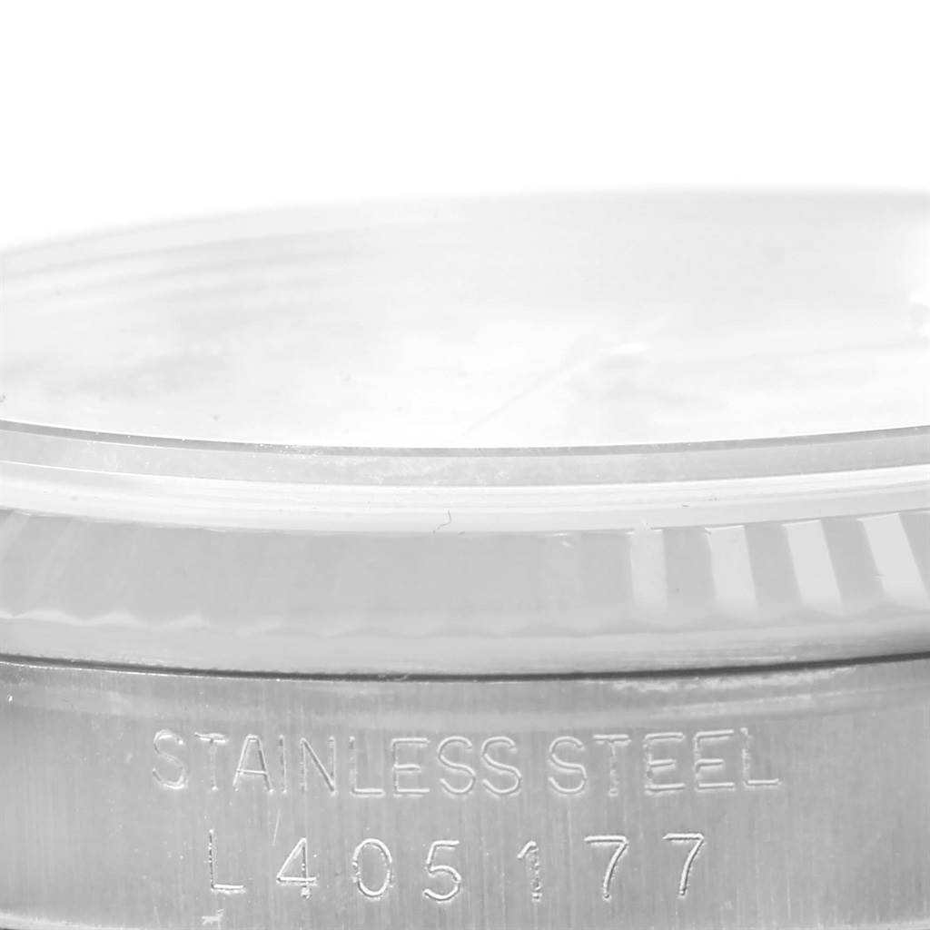 This close-up image shows the side of the stainless steel case of a Rolex Datejust 16234 Men's Stainless Steel Beige Dial 16234 Men's Stainless Steel Beige Dial watch with some model identification.