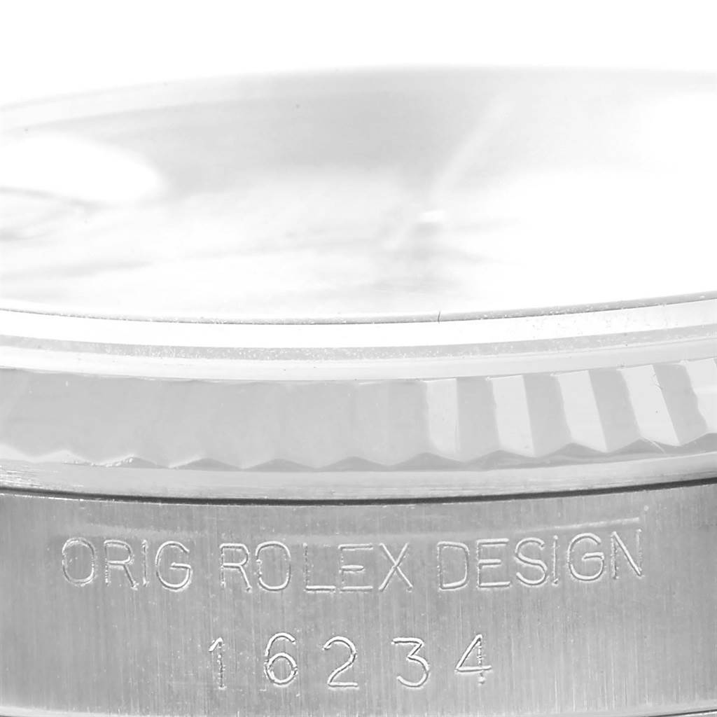 This close-up image shows the side engraving of a Rolex Datejust 16234 Men's Stainless Steel Beige Dial 16234 Men's Stainless Steel Beige Dial, revealing the model number "16234" and "ORIG ROLEX DESIGN."