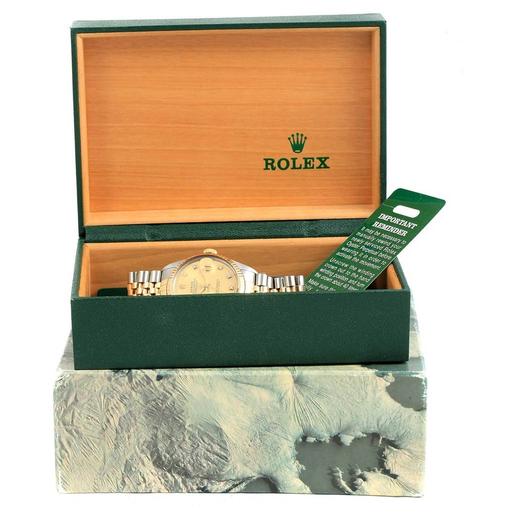 The image shows a Rolex Datejust 16013 Men's Stainless Steel Champagne Dial 16013 Men's Stainless Steel Champagne Dial watch in its opened green and wooden box, along with an attached green "Important Reminder" tag.