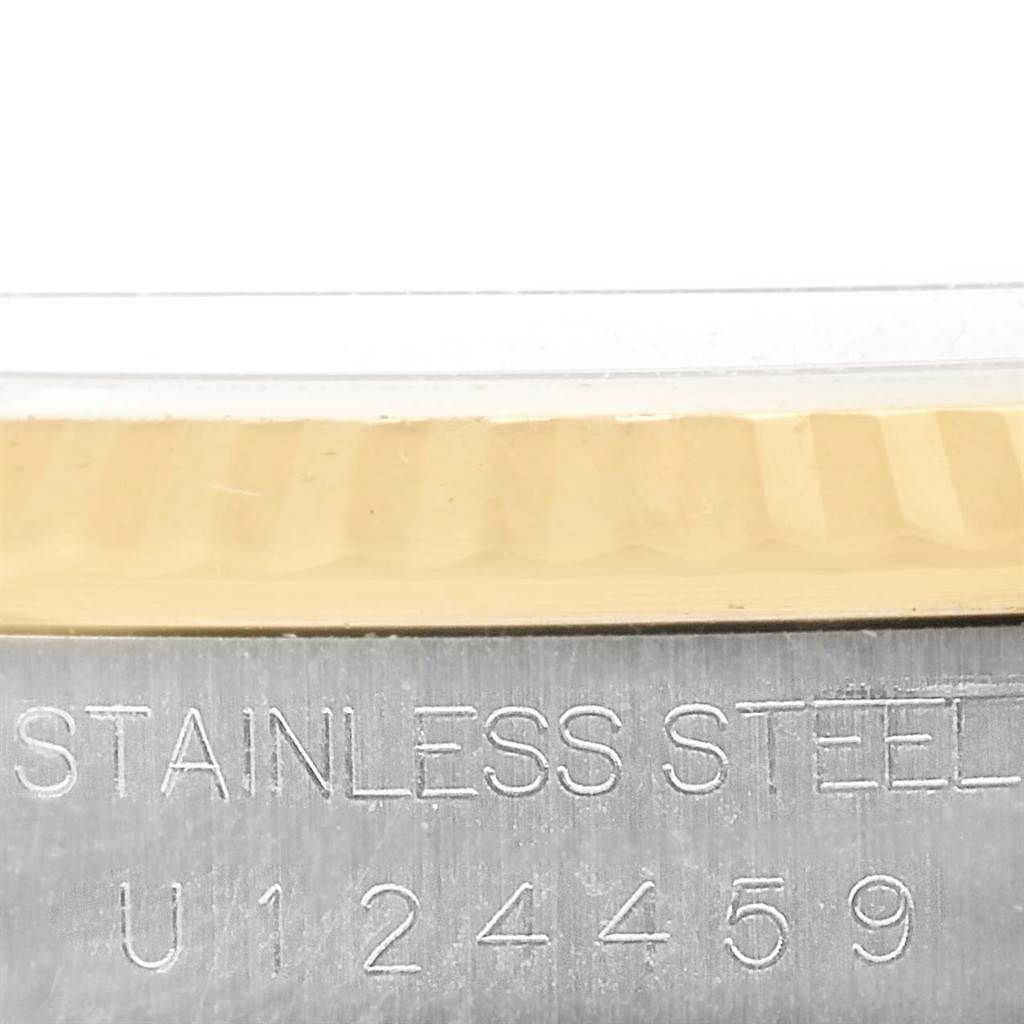 The image shows a close-up of the stainless steel case and serial number of a Rolex Datejust 16233 Men's Steel and Gold (two tone) Champagne Dial 16233 Men's Steel and Gold (two tone) Champagne Dial watch.