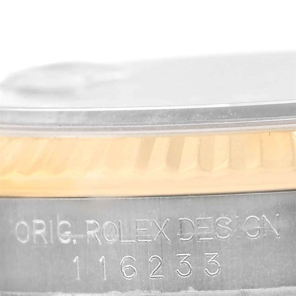 This close-up image shows the side view of a Rolex Datejust 116233 Men's Stainless Steel Champagne Dial 116233 Men's Stainless Steel Champagne Dial watch with the model number and "ORIG. ROLEX DESIGN" inscription visible.