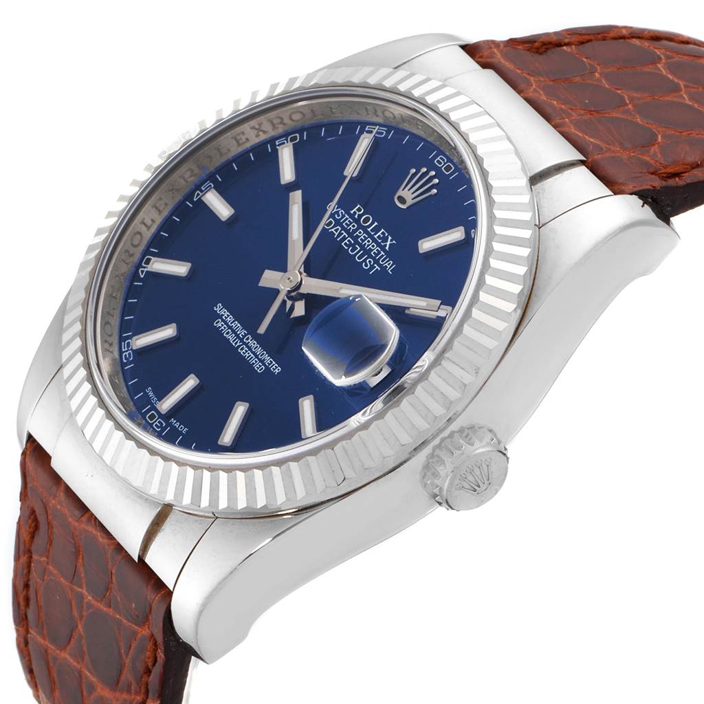This Rolex Datejust 116139 Men's White Gold Blue Dial 116139 Men's White Gold Blue Dial watch is shown at an angle, featuring the blue dial, fluted bezel, crown, and brown strap.