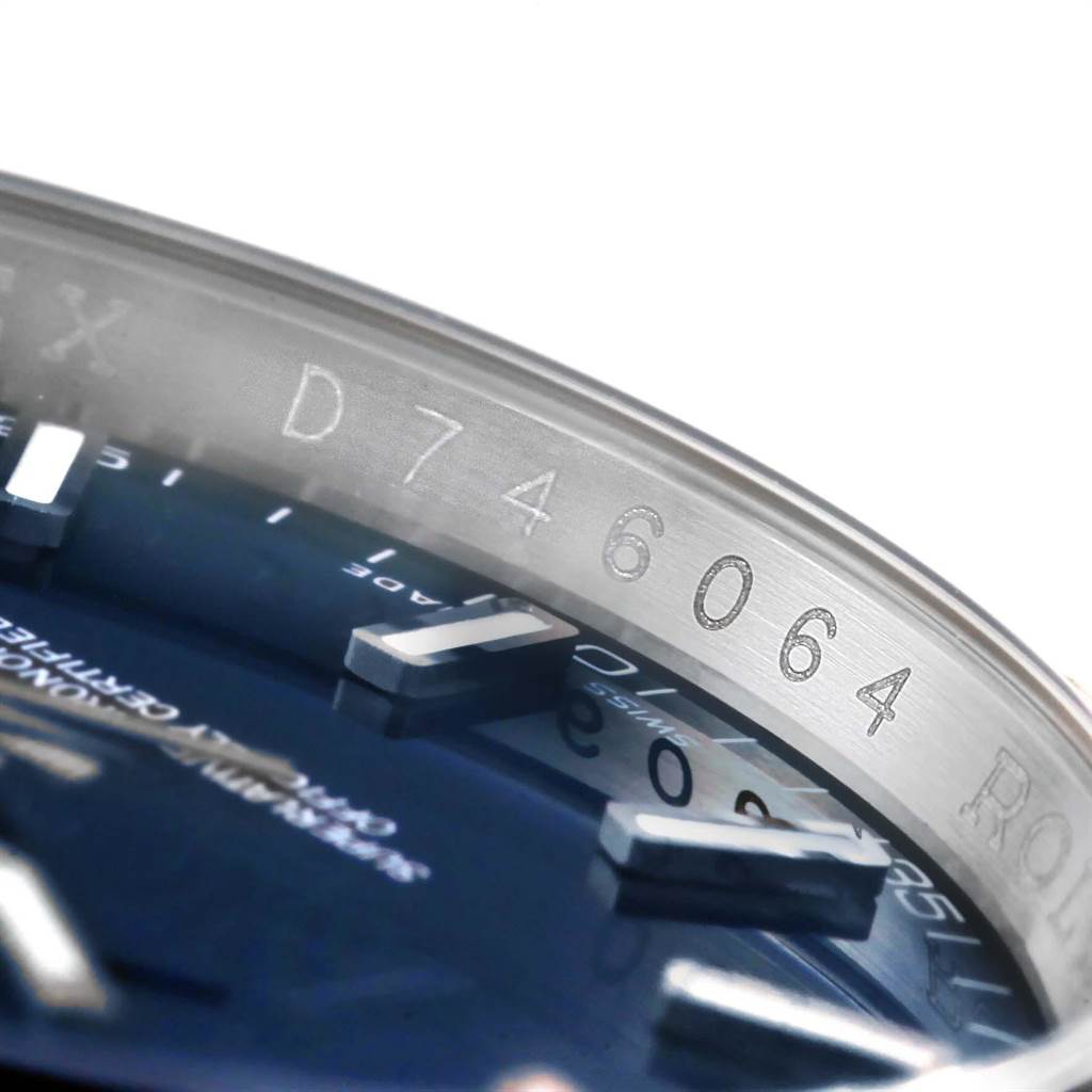 The image shows a close-up of the serial number engraved on the bezel and part of the dial of the Rolex Datejust 116139 Men's White Gold Blue Dial 116139 Men's White Gold Blue Dial watch.