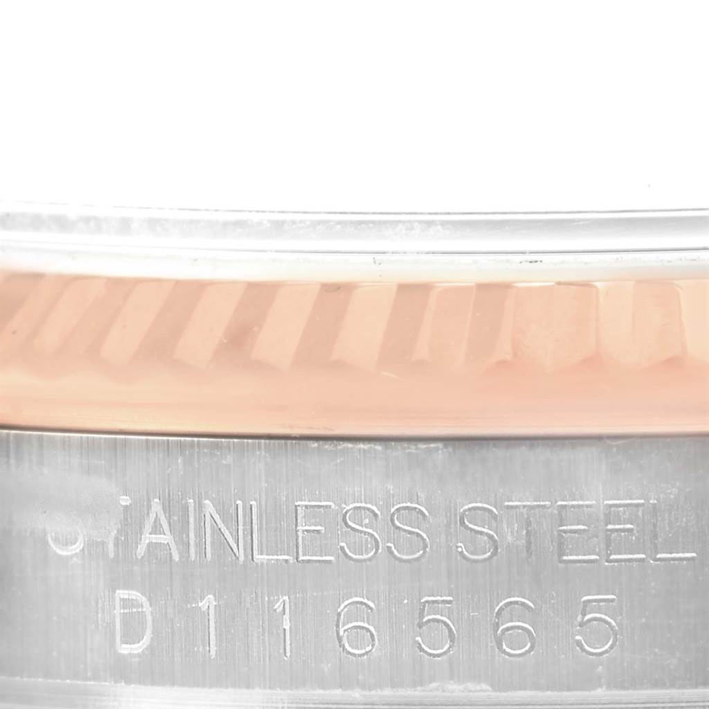 This close-up image shows the bezel and part of the caseback of a Rolex Datejust 116231 Men's Steel and Gold (two tone) Black Dial 116231 Men's Steel and Gold (two tone) Black Dial, including an engraving.