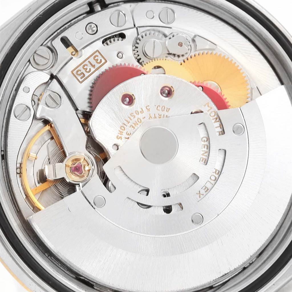The image shows a close-up view of the movement mechanism of a Rolex Datejust 16233 Men's Steel and Gold (two tone) Beige Dial 16233 Men's Steel and Gold (two tone) Beige Dial watch, focusing on the gears and intricate parts.