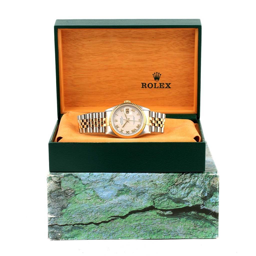 The Rolex Datejust 16233 Men's Steel and Gold (two tone) Beige Dial 16233 Men's Steel and Gold (two tone) Beige Dial watch is displayed front-facing in an open green and orange box with the Rolex logo visible.