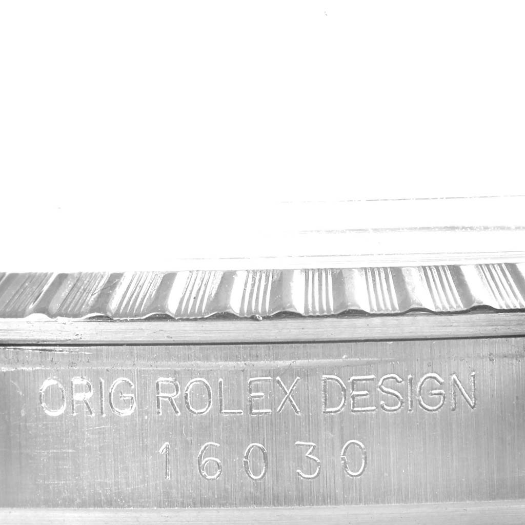 This image shows a close-up of the engraved side of the Datejust Rolex watch, featuring the model number 16030.