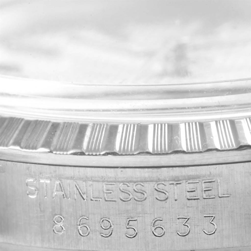 This image shows a macro view of the serial number and stainless steel labeling on a Rolex Datejust 16030 Men's Stainless Steel Silver Dial 16030 Men's Stainless Steel Silver Dial watch case.