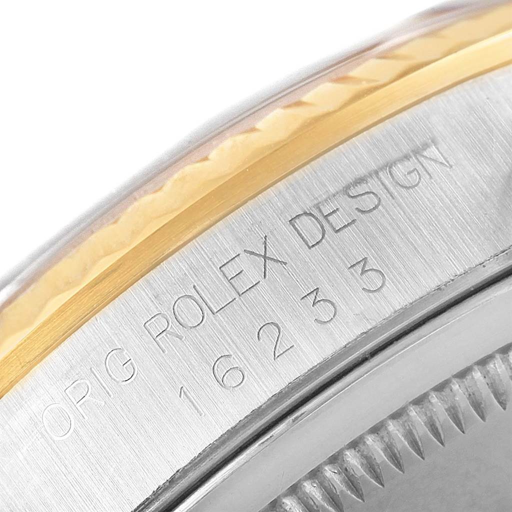 The image shows a close-up view of the side of a Rolex Datejust 16233 Men's Steel and Gold (two tone) Champagne Dial 16233 Men's Steel and Gold (two tone) Champagne Dial watch, highlighting its model number and part of the bezel.