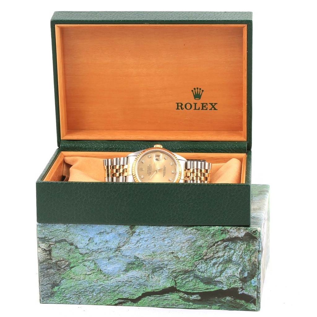 The Rolex Datejust 16233 Men's Steel and Gold (two tone) Champagne Dial 16233 Men's Steel and Gold (two tone) Champagne Dial watch is shown front-facing inside an open green and wooden Rolex box.