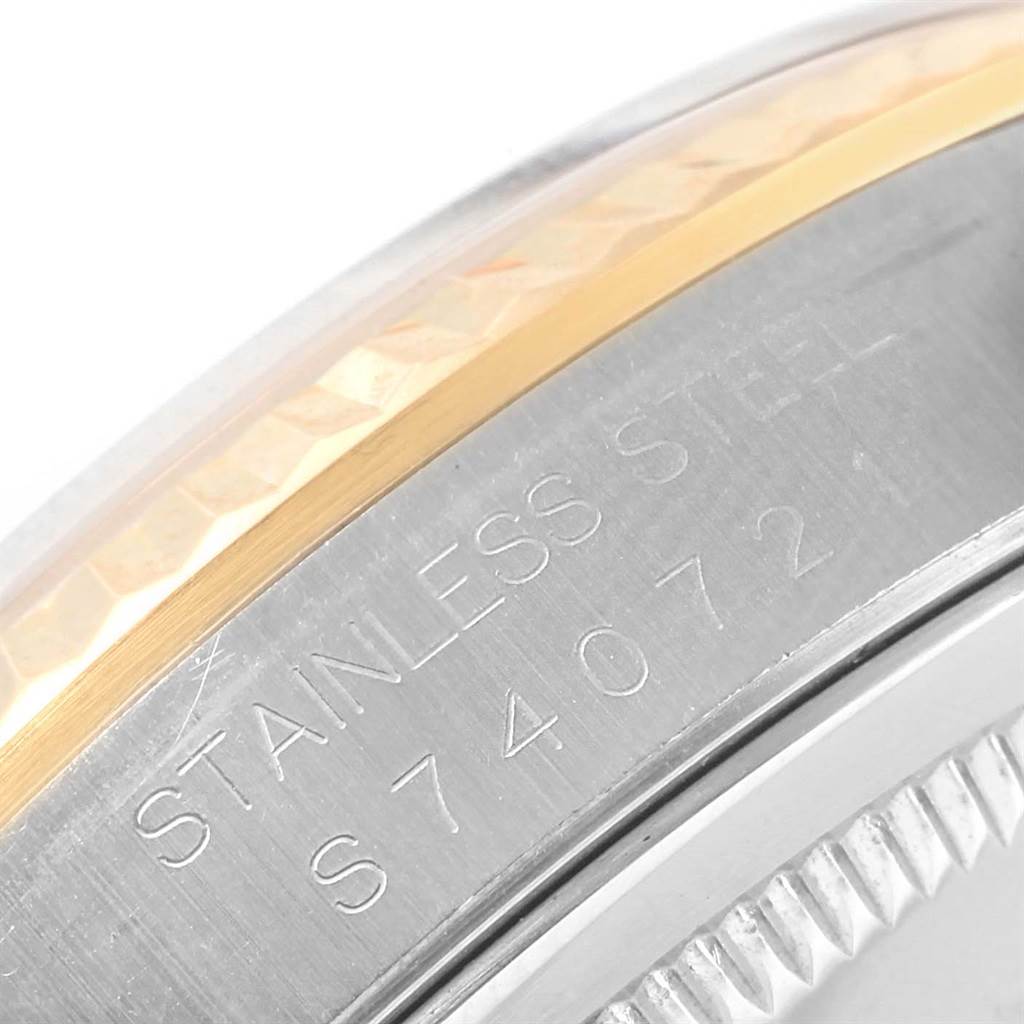 The image shows a close-up of the case back and edge of the bezel of a Rolex Datejust 16233 Men's Steel and Gold (two tone) Champagne Dial 16233 Men's Steel and Gold (two tone) Champagne Dial, with "STAINLESS STEEL" engraving visible.