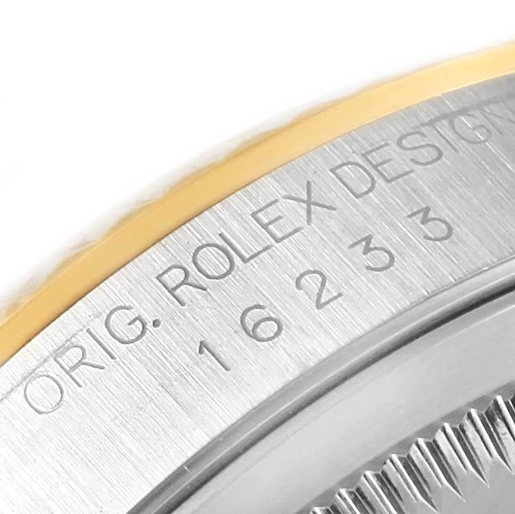 The image shows a close-up of the side of a Rolex Datejust 16233 Men's Steel and Gold (two tone) Champagne Dial 16233 Men's Steel and Gold (two tone) Champagne Dial watch case, featuring the model number and fluted bezel.
