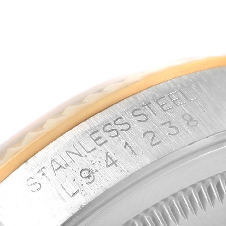 The image shows a close-up of the Rolex Datejust 16233 Men's Steel and Gold (two tone) Champagne Dial 16233 Men's Steel and Gold (two tone) Champagne Dial model's stainless steel case with engraved text.