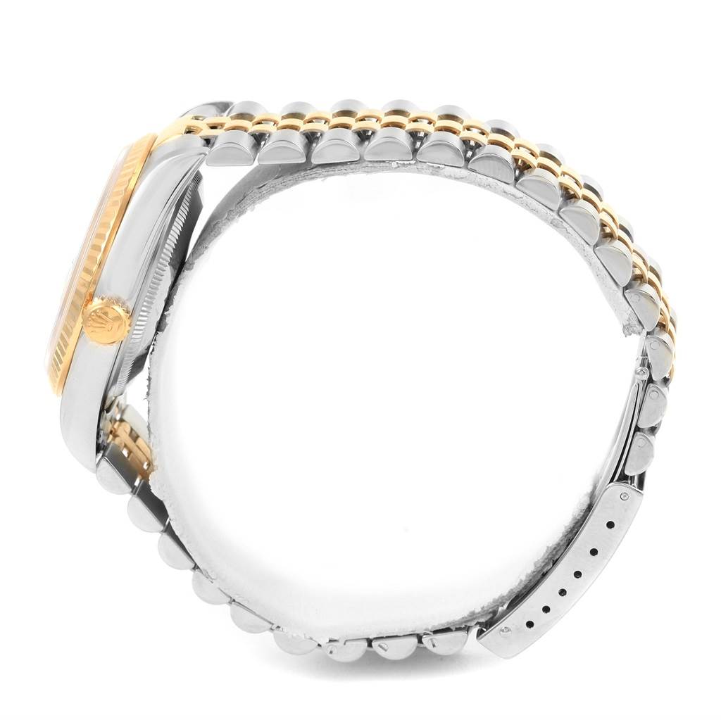 The image shows a side view of a Rolex Datejust 16233 Men's Steel and Gold (two tone) Champagne Dial 16233 Men's Steel and Gold (two tone) Champagne Dial watch, highlighting its case, dial, crown, and two-tone bracelet.