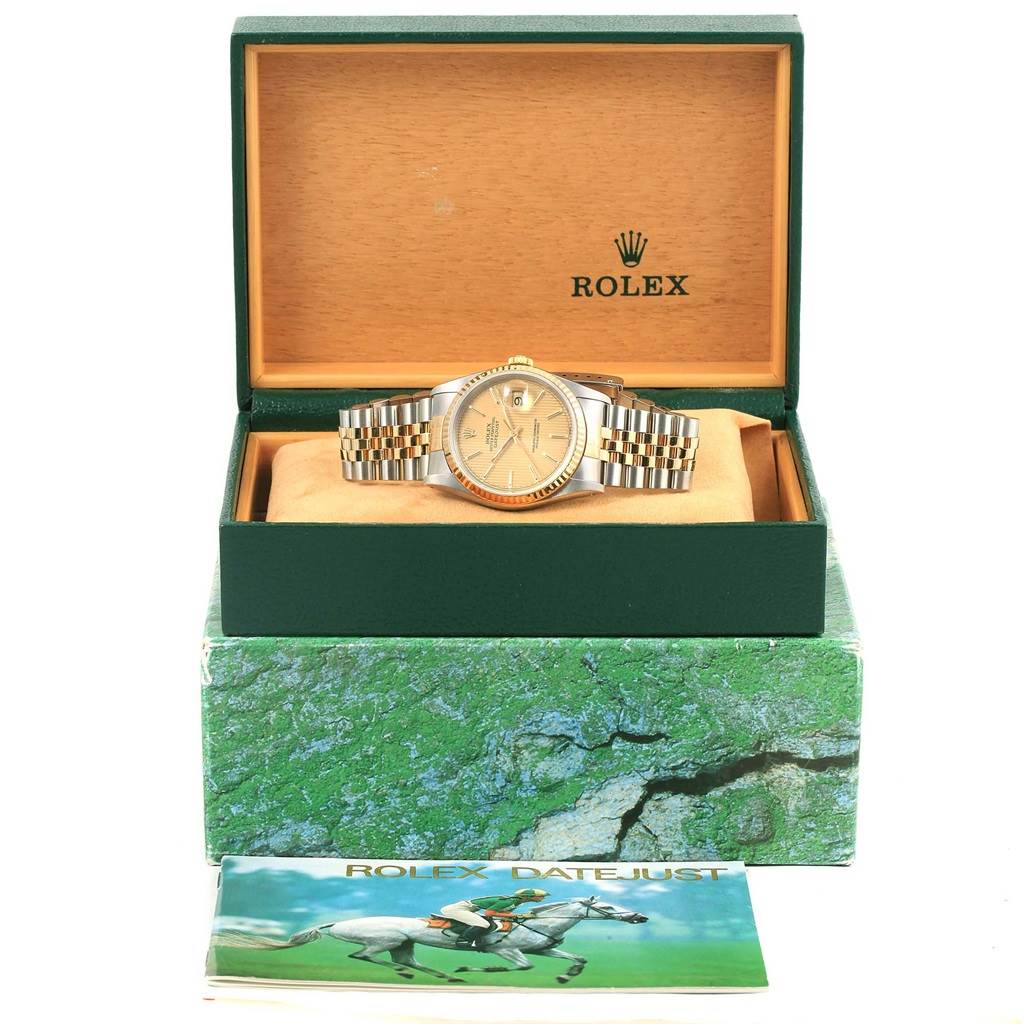 The Rolex Datejust 16233 Men's Steel and Gold (two tone) Champagne Dial 16233 Men's Steel and Gold (two tone) Champagne Dial watch is displayed inside its open box, with booklets and packaging visible.