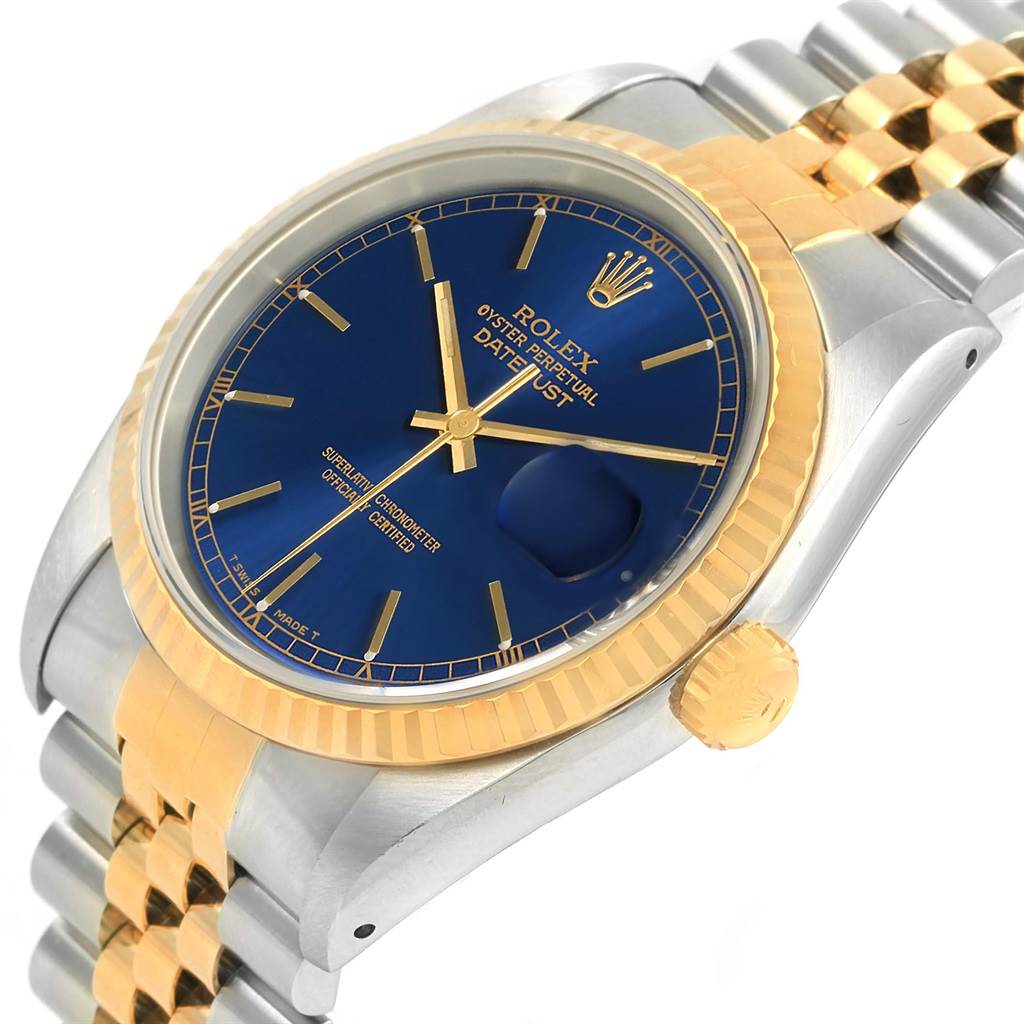 The Rolex Datejust 16233 Men's Steel and Gold (two tone) Blue Dial 16233 Men's Steel and Gold (two tone) Blue Dial watch is shown at an angle displaying its blue dial, fluted bezel, crown, and part of the two-tone jubilee bracelet.