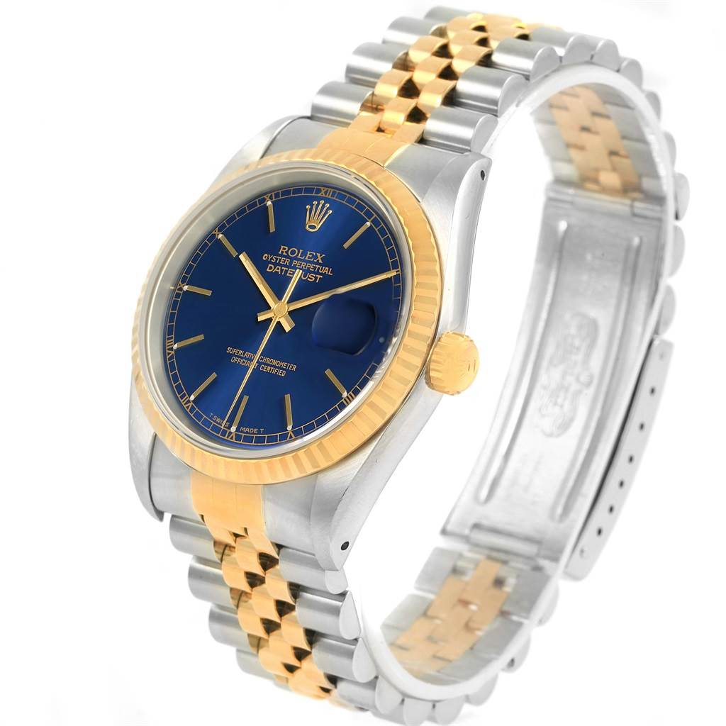 The image shows a Rolex Datejust 16233 Men's Steel and Gold (two tone) Blue Dial 16233 Men's Steel and Gold (two tone) Blue Dial watch angled from the front-left, detailing the blue dial, fluted bezel, and two-tone bracelet.