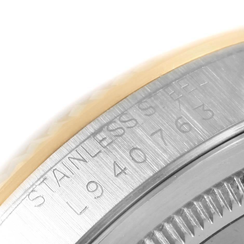 This image shows a close-up of the stainless steel and gold casing with the model number of a Rolex Datejust 16233 Men's Steel and Gold (two tone) Blue Dial 16233 Men's Steel and Gold (two tone) Blue Dial watch.