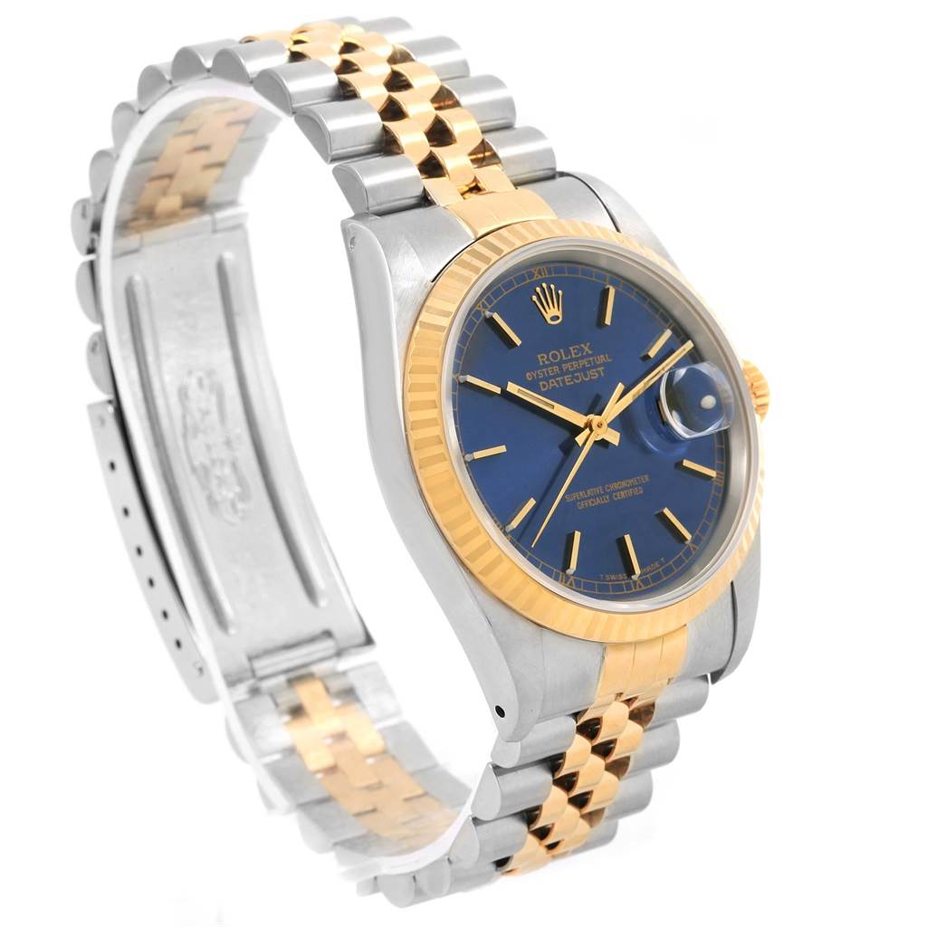The Rolex Datejust 16233 Men's Steel and Gold (two tone) Blue Dial 16233 Men's Steel and Gold (two tone) Blue Dial watch is shown at a slight angle, highlighting its blue dial, gold bezel, and two-tone bracelet.