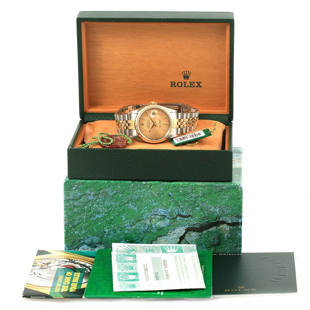 This image shows a Rolex Datejust 16233 Men's Steel and Gold (two tone) Champagne Dial 16233 Men's Steel and Gold (two tone) Champagne Dial watch viewed from the front, in its open box with accompanying documentation and tags.