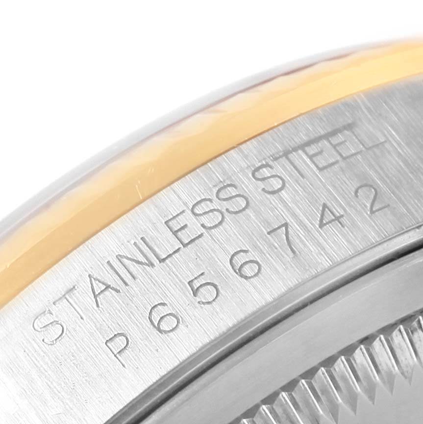 This image shows a close-up of the Rolex Datejust 16233 Men's Steel and Gold (two tone) Champagne Dial 16233 Men's Steel and Gold (two tone) Champagne Dial model's case back engraving, displaying "STAINLESS STEEL" and a serial number.