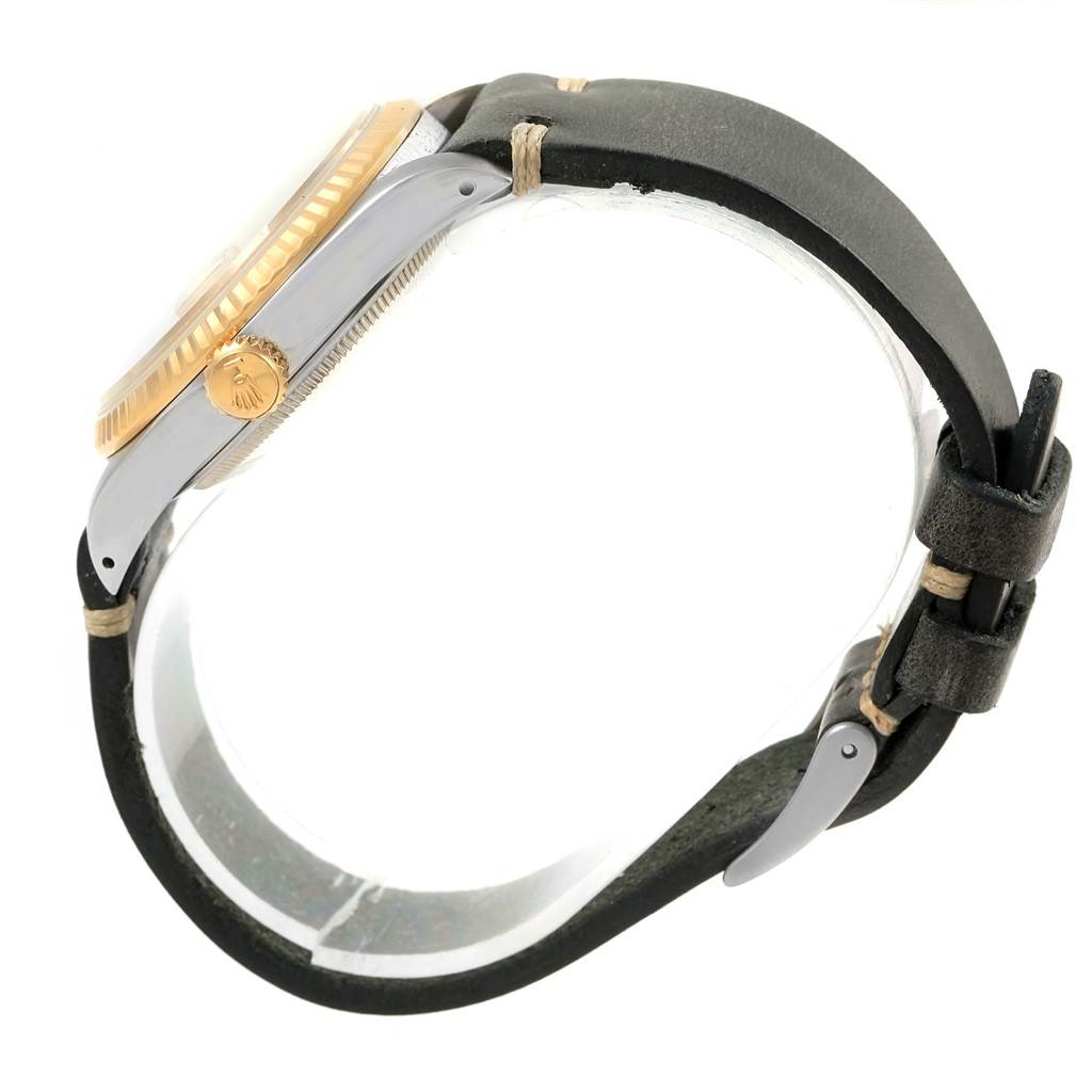 The image shows a side view of a Rolex Datejust 16233 Men's Steel and Gold (two tone) Champagne Dial 16233 Men's Steel and Gold (two tone) Champagne Dial watch, highlighting its crown, fluted bezel, and leather strap.