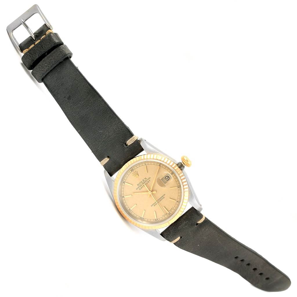 The image shows the Rolex Datejust 16233 Men's Steel and Gold (two tone) Champagne Dial 16233 Men's Steel and Gold (two tone) Champagne Dial watch at a slight diagonal angle with a clear view of the face, strap, bezel, and crown.