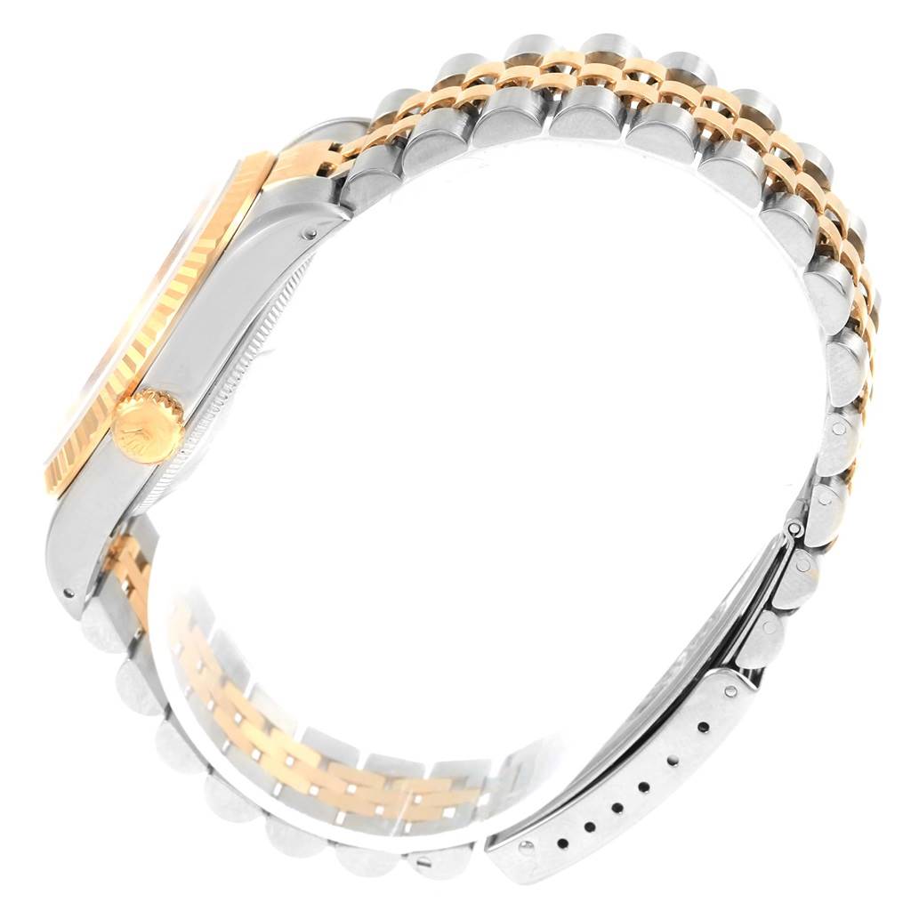 The image shows a side view of the Rolex Datejust 16233 Men's Steel and Gold (two tone) Beige Dial 16233 Men's Steel and Gold (two tone) Beige Dial watch, highlighting the bicolored metal strap and crown.