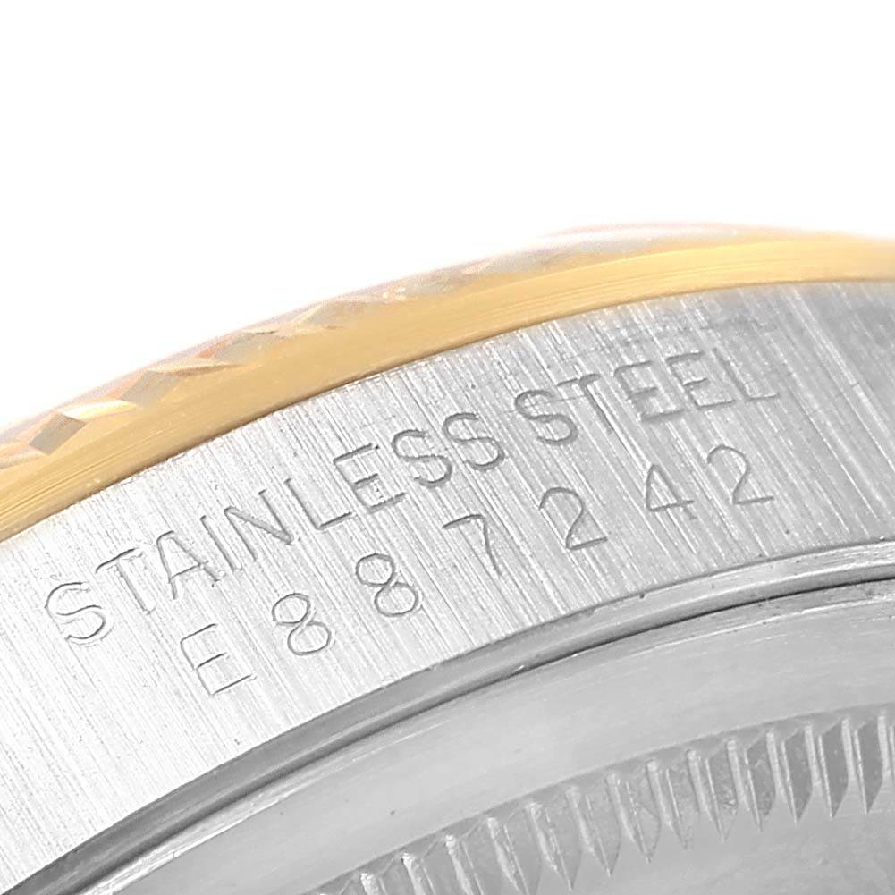 This is a close-up angle of the case back and bezel edge of a Rolex Datejust 16233 Men's Steel and Gold (two tone) Beige Dial 16233 Men's Steel and Gold (two tone) Beige Dial watch, showing the serial number and "Stainless Steel" engraving.