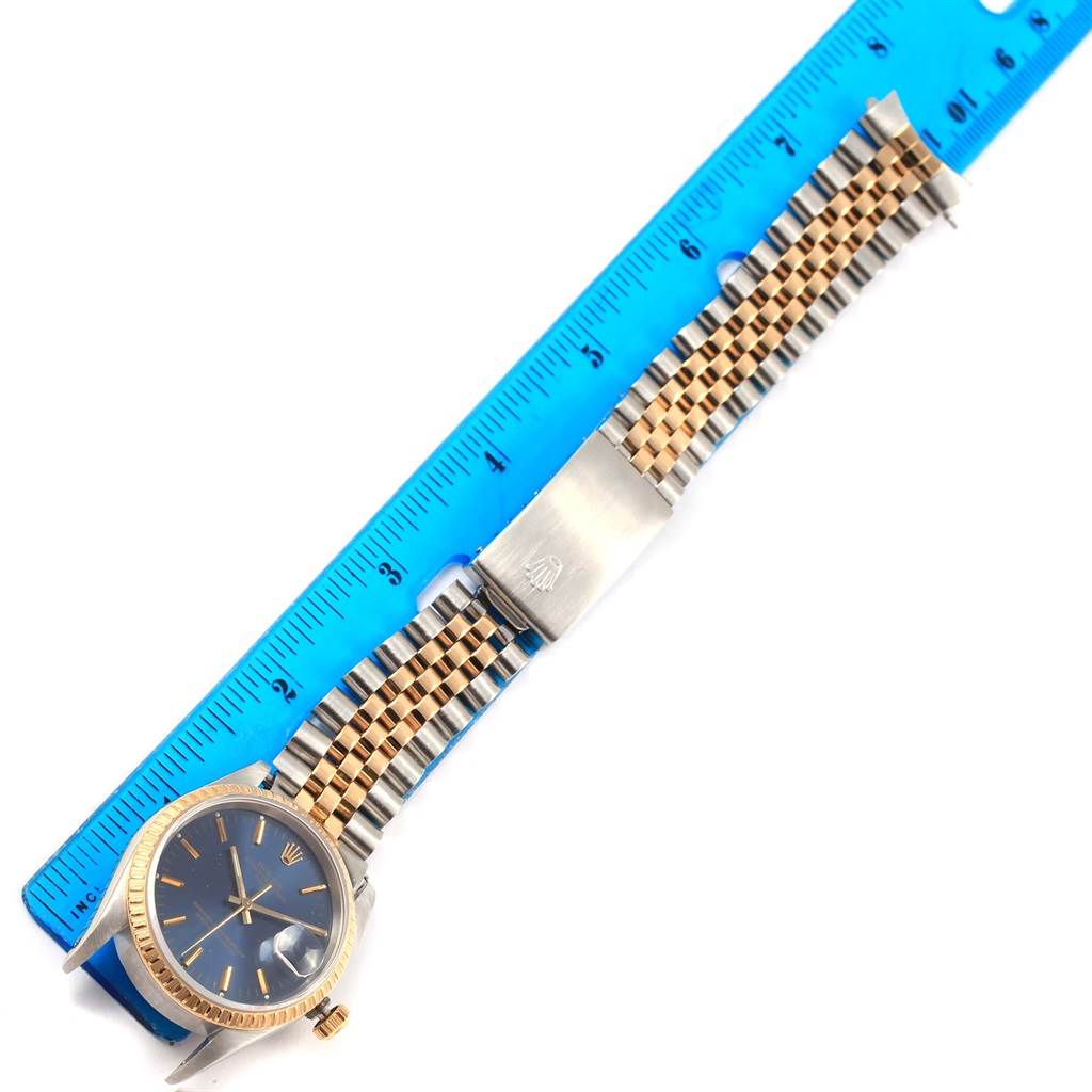 This image shows a top view of the Rolex Datejust 15223 Men's Steel and Gold (two tone) Blue Dial 15223 Men's Steel and Gold (two tone) Blue Dial watch with its face, bezel, and metal bracelet measuring about 7 inches.