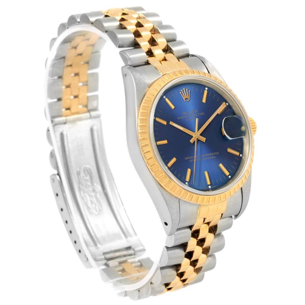 The image shows a Rolex Datejust 15223 Men's Steel and Gold (two tone) Blue Dial 15223 Men's Steel and Gold (two tone) Blue Dial watch at an angle highlighting the blue dial, gold fluted bezel, and two-tone bracelet.