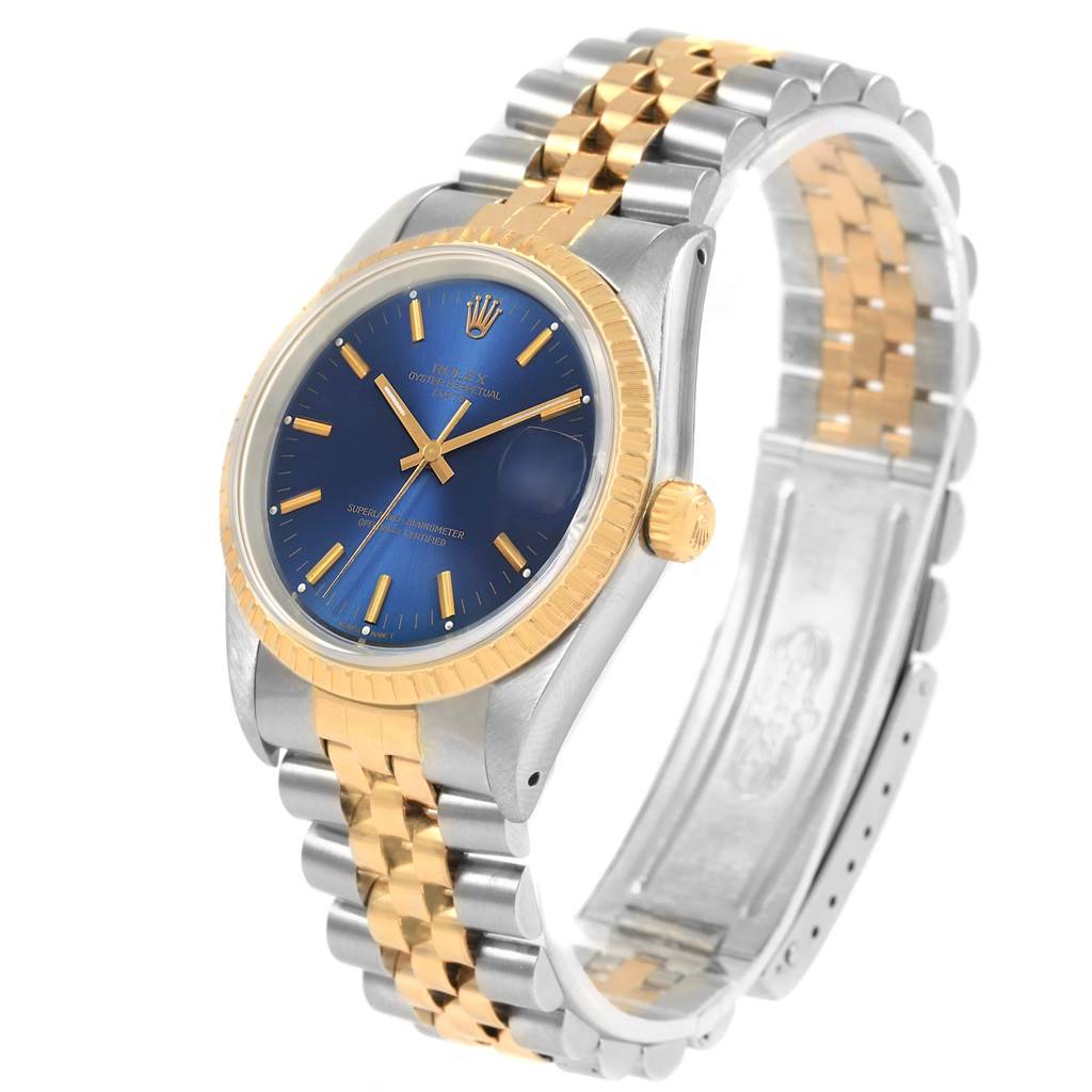 The image shows a Rolex Datejust 15223 Men's Steel and Gold (two tone) Blue Dial 15223 Men's Steel and Gold (two tone) Blue Dial watch at a three-quarter angle, highlighting its two-tone bracelet and blue dial with gold markers.