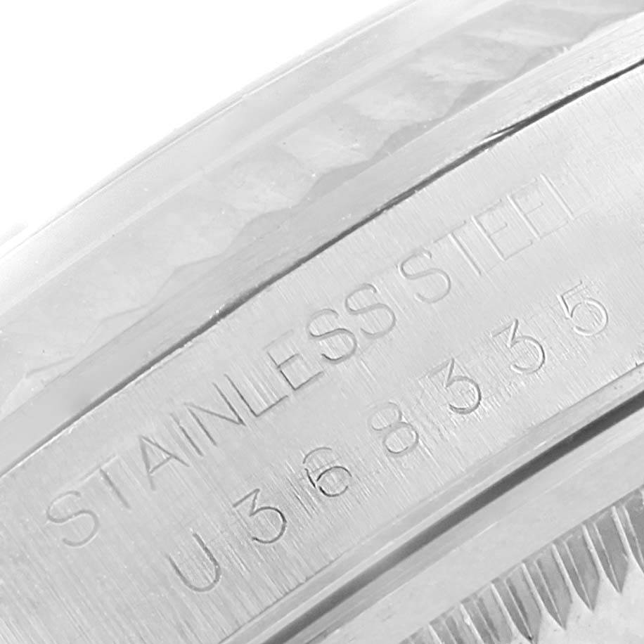The image shows an angled close-up of the stainless steel casing and serial number of the Rolex Datejust 16234 Men's Stainless Steel Black Dial 16234 Men's Stainless Steel Black Dial watch.
