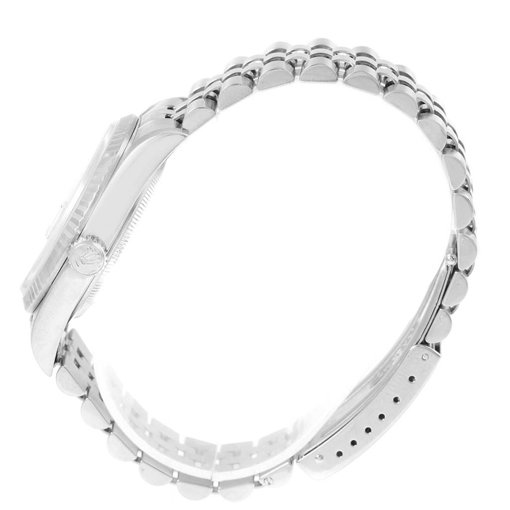 This side-angle view shows the case, fluted bezel, crown, and Jubilee bracelet of the Rolex Datejust 16234 Men's Stainless Steel Black Dial 16234 Men's Stainless Steel Black Dial watch.