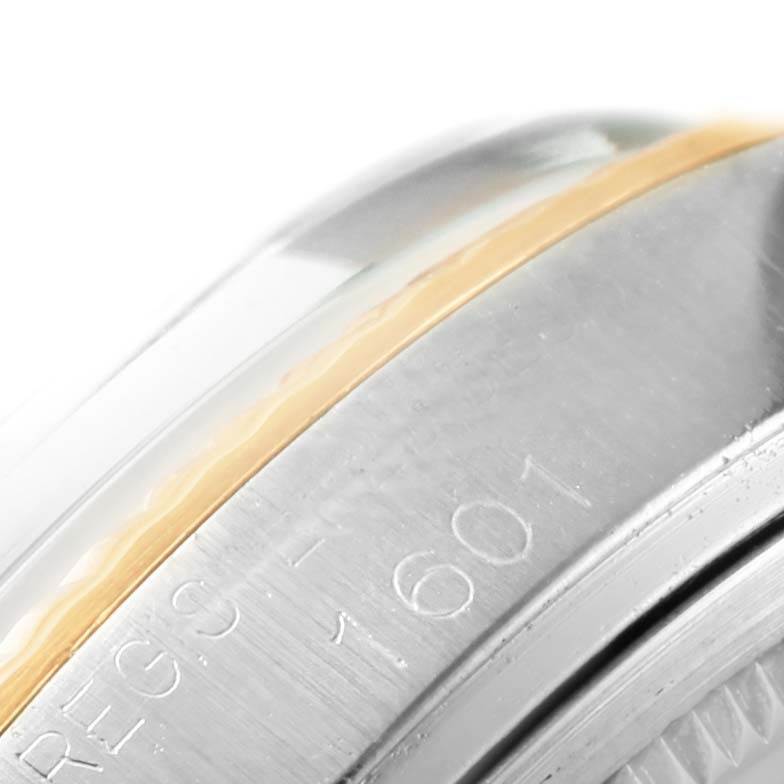 The image shows a close-up of the Rolex Datejust 1601 Men's Stainless Steel Silver Dial 1601 Men's Stainless Steel Silver Dial model 1601's bezel and part of the case, highlighting the serial number and metal finish.