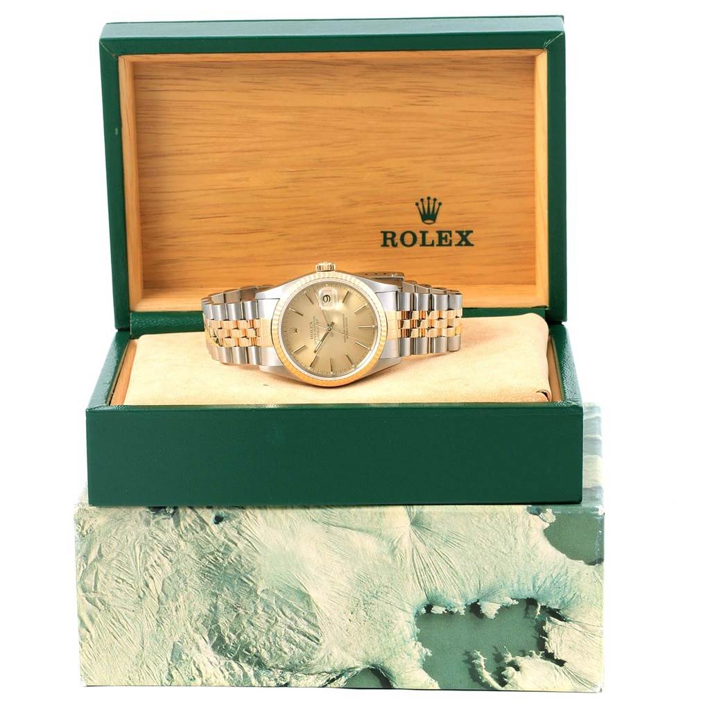 The image shows a Rolex Datejust 16233 Steel and Gold (two tone) Champagne Dial 16233 Steel and Gold (two tone) Champagne Dial watch in its open green and wooden box, displaying the face and the bi-metal bracelet.